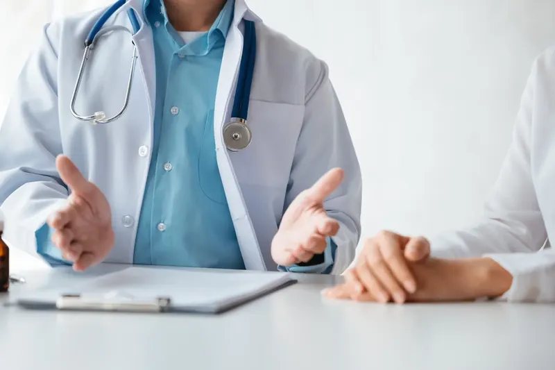 Doctor explaining options to a patient at a desk